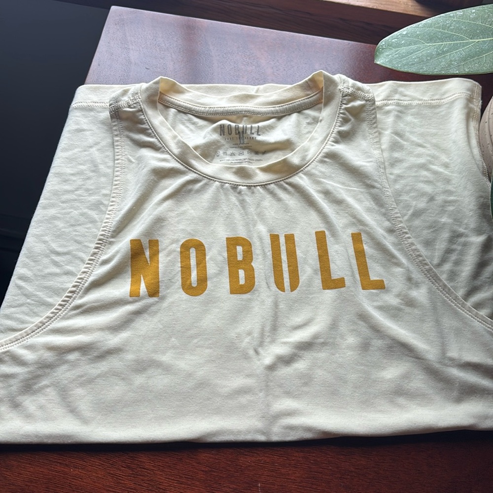NOBULL muted yellow and gold tank top. 
Like new. Wrong size.